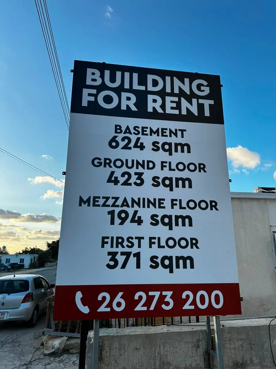 Building for rent sign on a commercial property