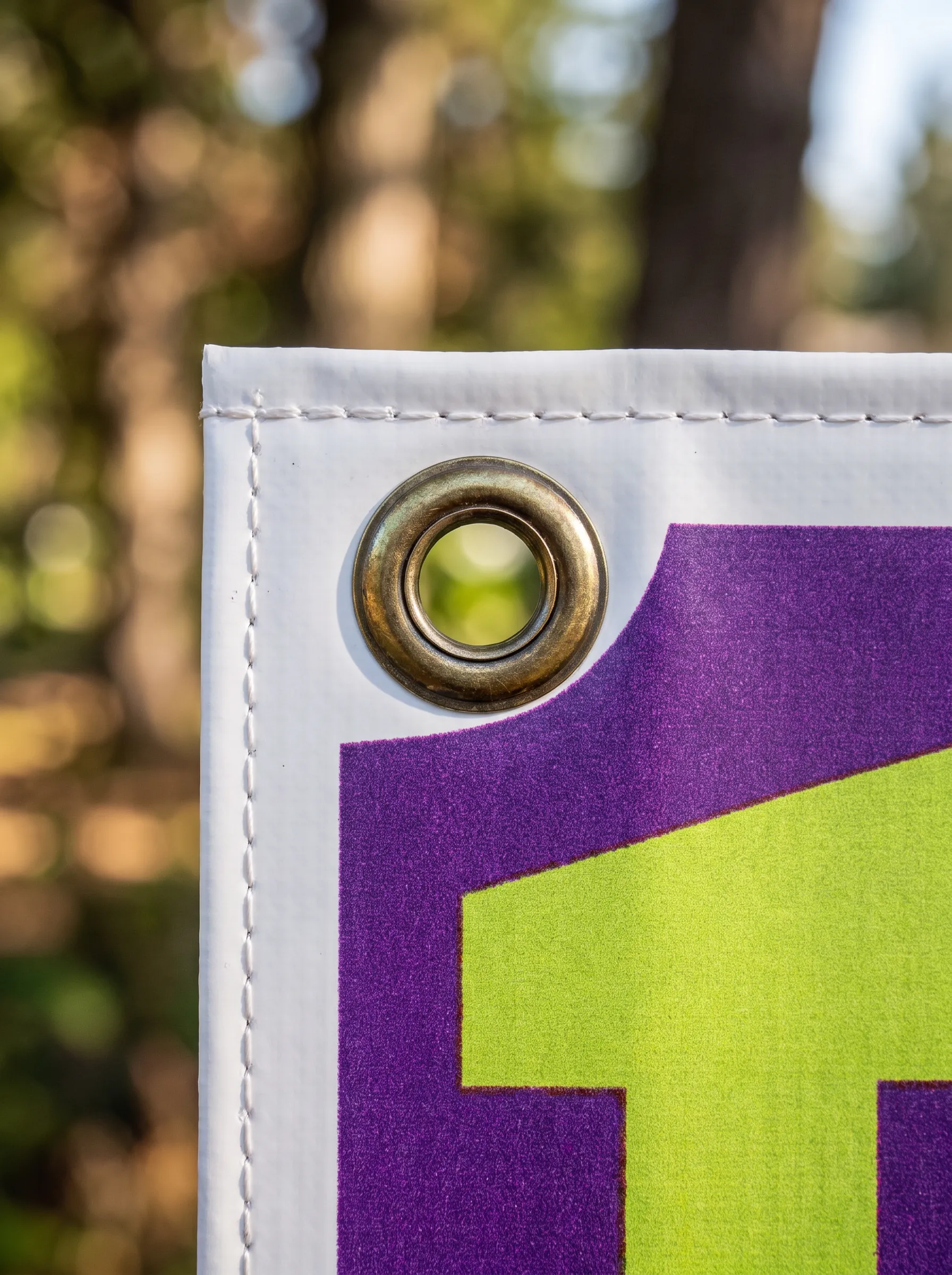 Close-up of a PVC banner with a brass eyelet